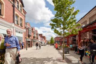 After shot of Altrincham after public realm works have been completed, complete with street trees and new paving setts.