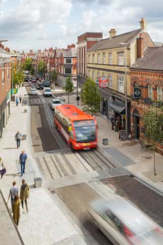 Birds eye view of a street in Altrincham showing road improvements including a new courtesy crossing and a red bus.
