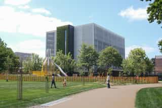 An image of Ancoats Green with Ancoats Hub in the background