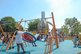 An image of kids using the play equipment at Ancoats Green