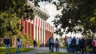 An image of people walking towards the Anfield Stadium