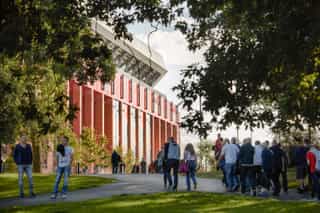 An image of people walking towards the Anfield Stadium