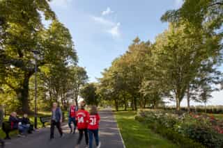 A photo of fans walking on a path through Stanley Park
