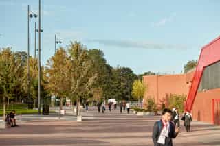 An image of people walking past the Anfield Stadium