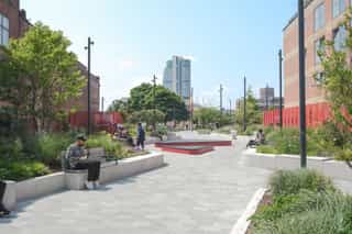 an image of people sitting and enjoying their lunch break on benches at Leeds South Bank