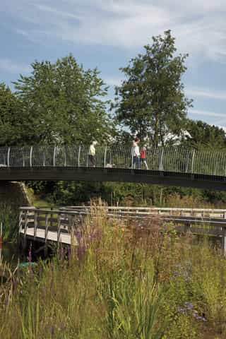 People walking on a bridge in a park