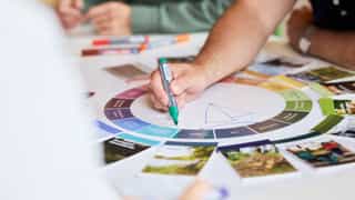 Close up shot of the Planit Regenerative Design Tool and a hand drawing on top of it as part of a round table workshop