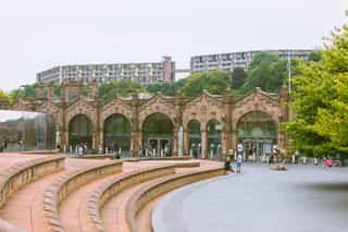 An wide angle image of Sheffield train station, people are hanging out in the space