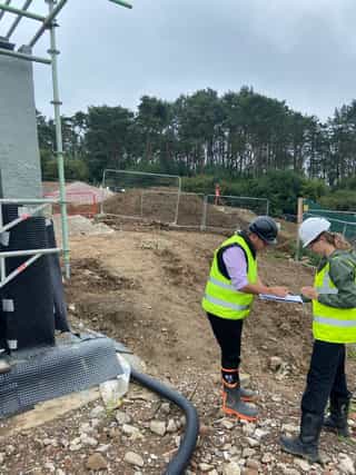 An image of two people on site