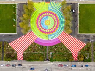 Aerial shot looking down at a bright mural painted on the ground